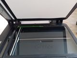 the printer is sitting on top of the table next to the printer