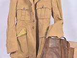 a tan jacket and a brown bag sitting on a table