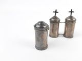 two silver salt and pepper shakers on a white surface