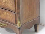 a small wooden chest of drawers with a clock on top of it
