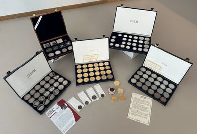 a lot of coins in a case on a table