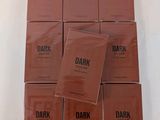 a group of six boxes of dark chocolate sitting on top of each other