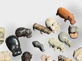 many different types of carved animals on a white surface
