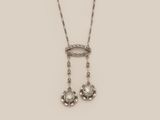 an image of a necklace and earrings with diamonds on a white background
