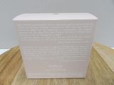 the box is open on a wooden table with a white wall in the background