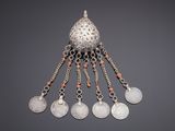 a silver pendant with coral beads and silver coins