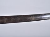 a close up of a knife with writing on it