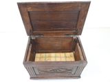 a small wooden chest with a plaid cushion inside
