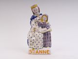 a figurine of a woman holding a child