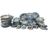 a pile of blue and white plates and bowls