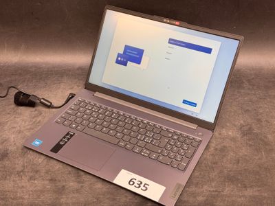 a laptop computer sitting on a table with a price tag on it
