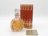 an image of a bottle of perfume sitting next to a box