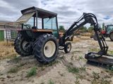 a tractor that is parked in the dirt