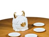 an image of a table with plates and a vase on it