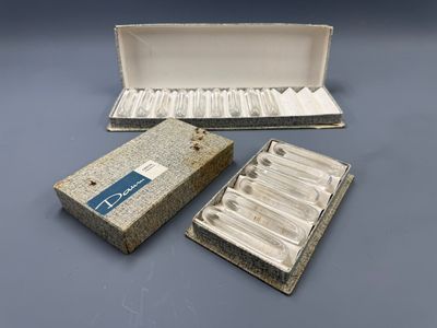 two boxes of cigarettes sitting on top of a table next to a box of cigarettes