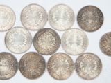 several different types of coins are arranged on a white surface