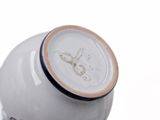 a white vase with a clock on the top of it