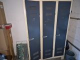 two blue lockers in the corner of a room