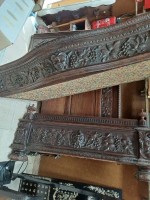 a bed that has a wooden headboard on top of it