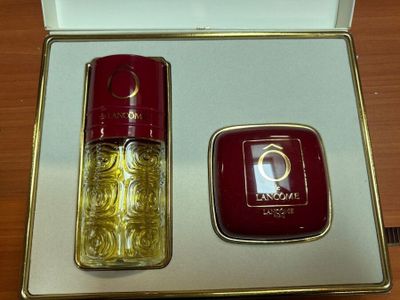 an image of a bottle of perfume next to a box