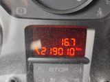 a close up of a digital clock on a car ' s dashboard