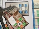 a pile of stamps on top of a binder next to a pair of scissors