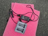 a pink towel with a charger and a charger attached to it