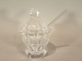 a glass jar with a spoon in it on a table