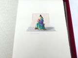 un livre ouvert sur lequel figure le dessin d'une femme assise sur une chaise