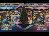 two packs of pokemon trading cards in a display case
