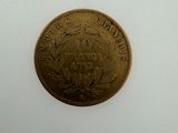 an old coin with a crown on it sitting on top of a white surface