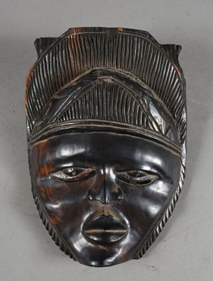 an image of a wooden mask on a white surface