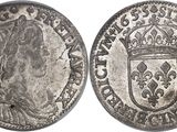 a silver coin with a crown on top of it