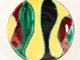 a close up of a colorful bowl on a white surface