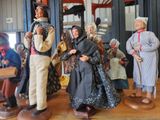 many figurines of people that are standing on a table