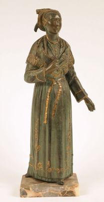 statue of a woman in a green dress with a hat on her head