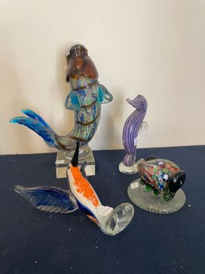 two figurines of fish and a turtle on a table