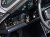 a steering wheel and dashboard of a car with a clock on it