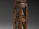 an image of a wooden lantern with carvings on it