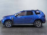 the blue dacia is parked in a room with a gray wall