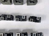 many pieces of metal that are on a white surface