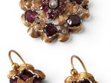 a close up of a pair of earrings and a broochle