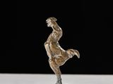 statue of a man riding a horse on a white surface