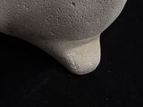 a white vase sitting on a table with a black background
