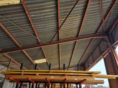 underside of a metal roof with a row of surfboards on it