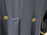 a close up of a coat with buttons on it