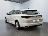 the rear end of a white car parked in a garage