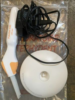 a white and orange electric hair dryer next to a black and white hair dryer
