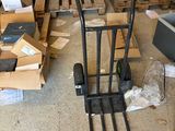 many boxes and a hand truck in a garage