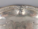 a silver plate with a design on the top of it